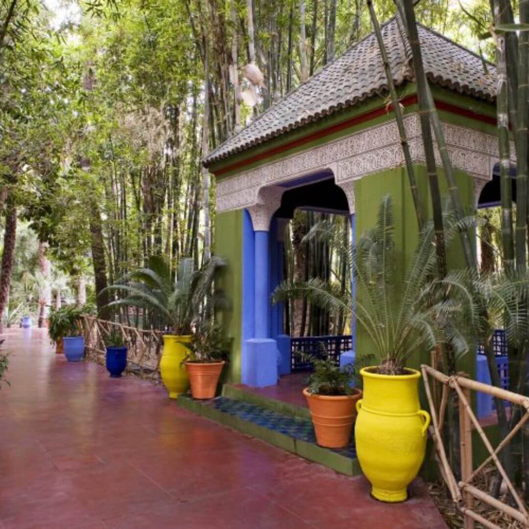 Colorful plants, fountains, and blue architecture in Majorelle Garden, Marrakech